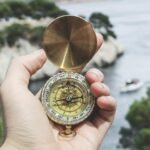 person holding compass