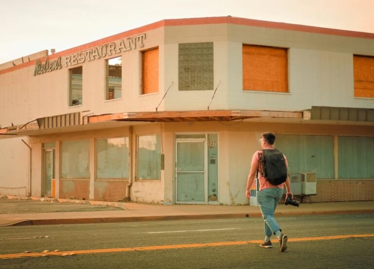 man with backpack crossing the road